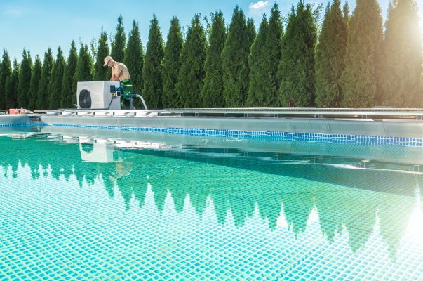 HVAC Technician Testing New Device Next to the Pool.